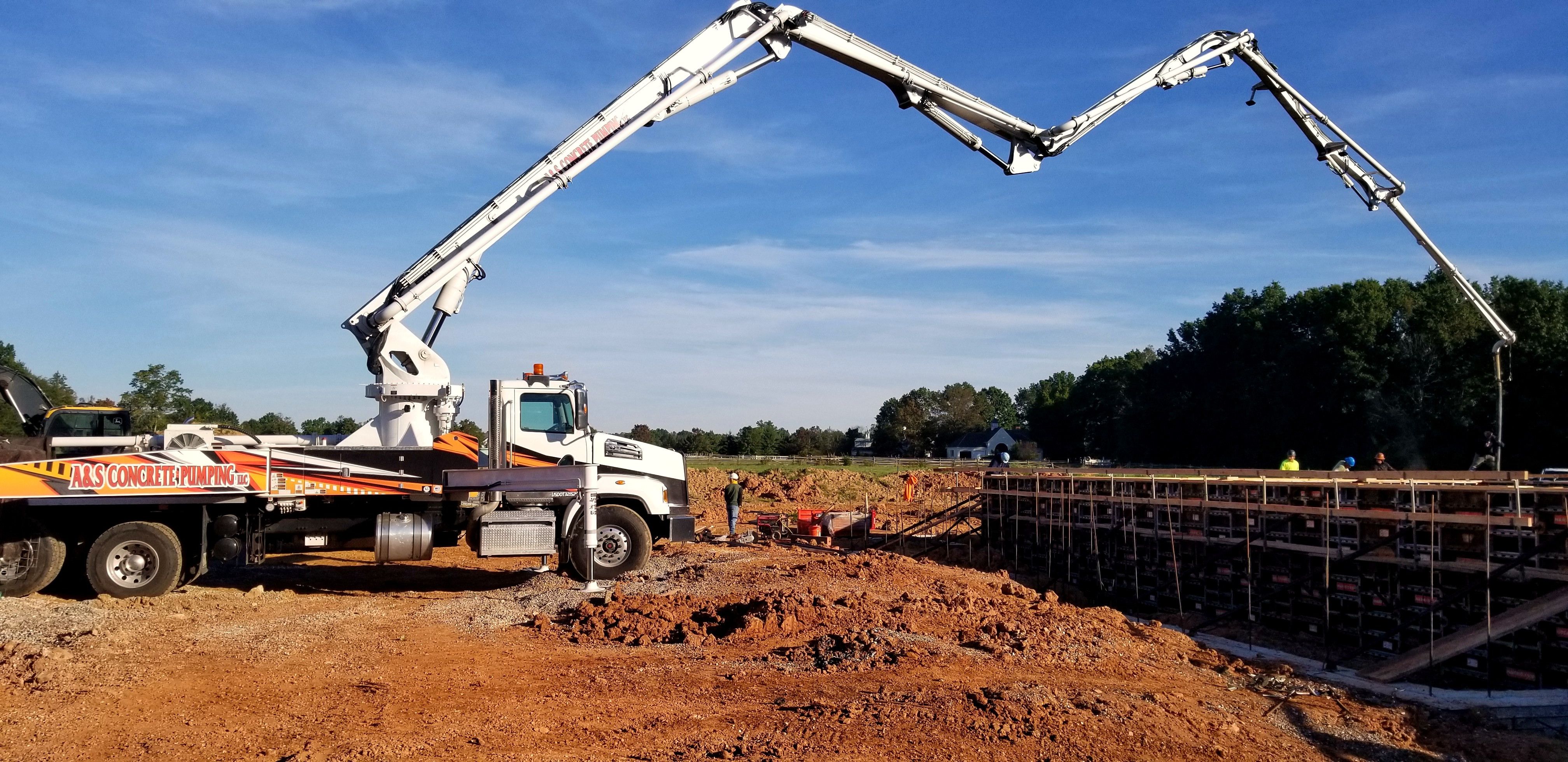 A&S boom truck with the boom extended over a pour