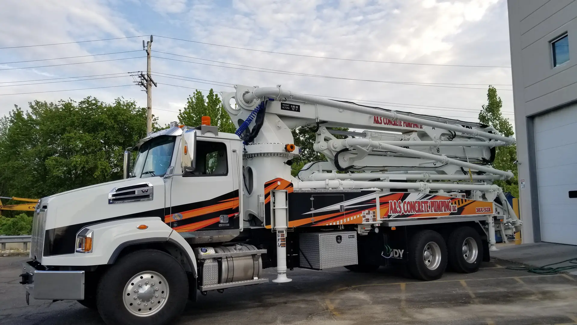 A&S Concrete Pumping DY boom pump truck parked with its boom folded