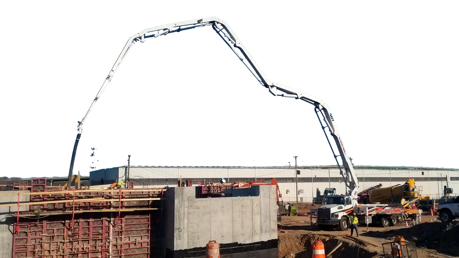 A&S Concrete Pumping boom pump fully extended over a commercial pour